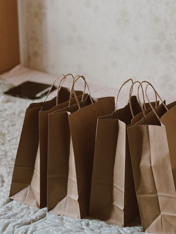 Several plain kraft paper shopping bags, third-party reference photograph
